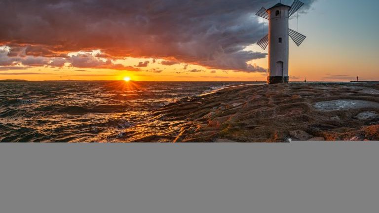 lighthouse in the shape of a windmill in Swinoujscie in Poland during the dramatic sunset shutterstock_1735966421.jpg